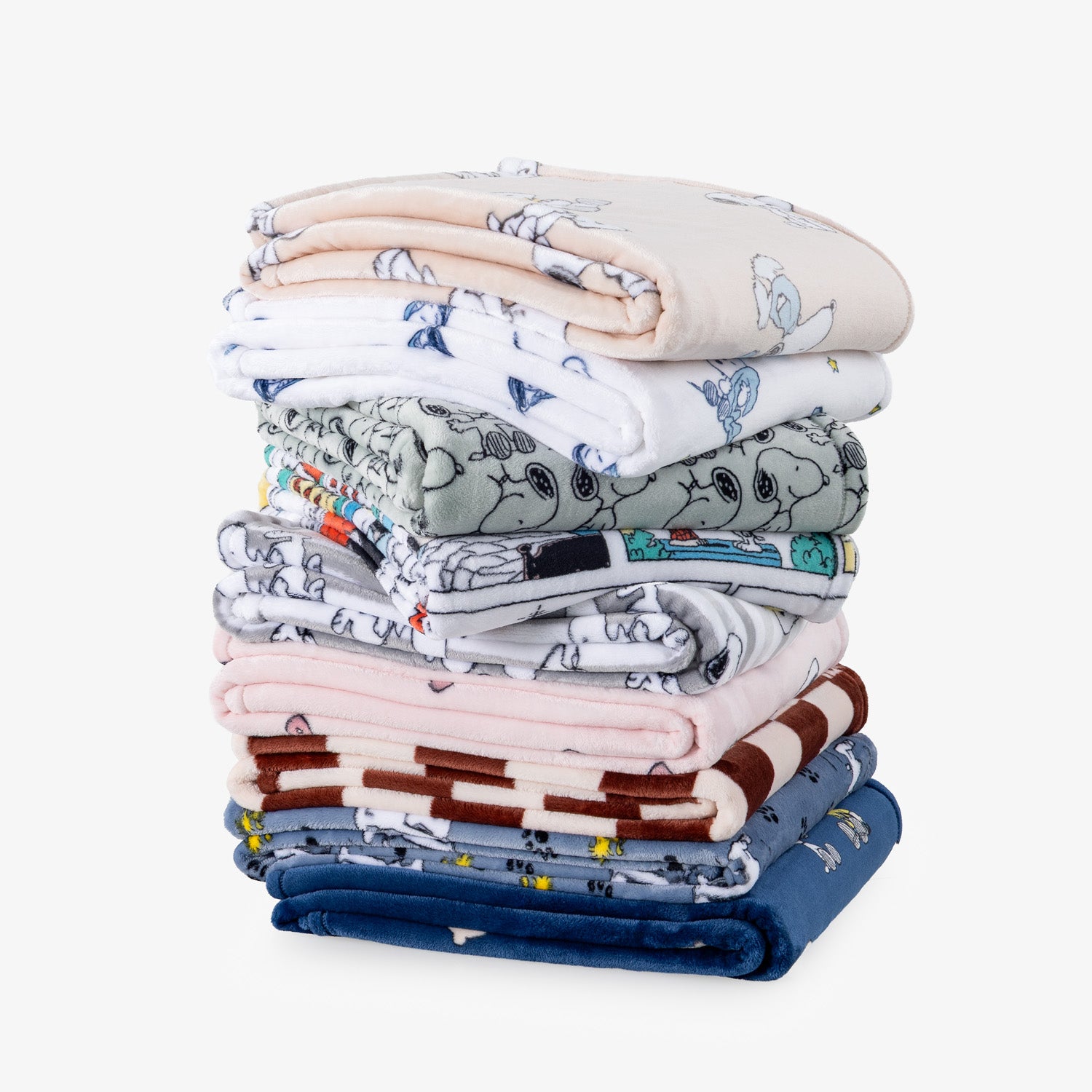 Stack of a variety of peanuts printed throws.