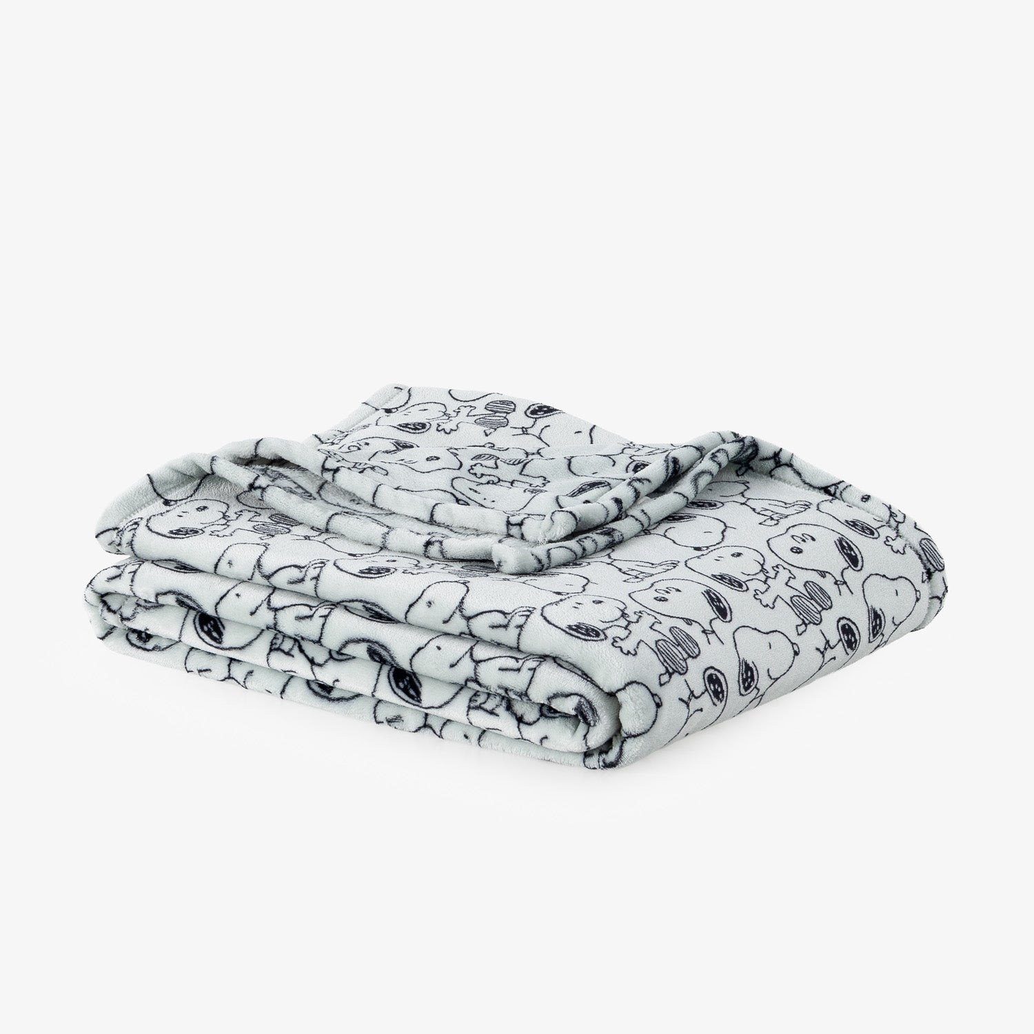 A folded blanket featuring a black and white cartoon character pattern, displayed on a clean white background.