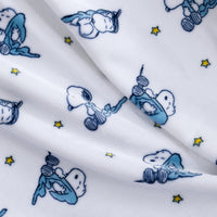 White fabric with a repeating print of Snoopy in a blue night outfit, accented with small yellow stars.