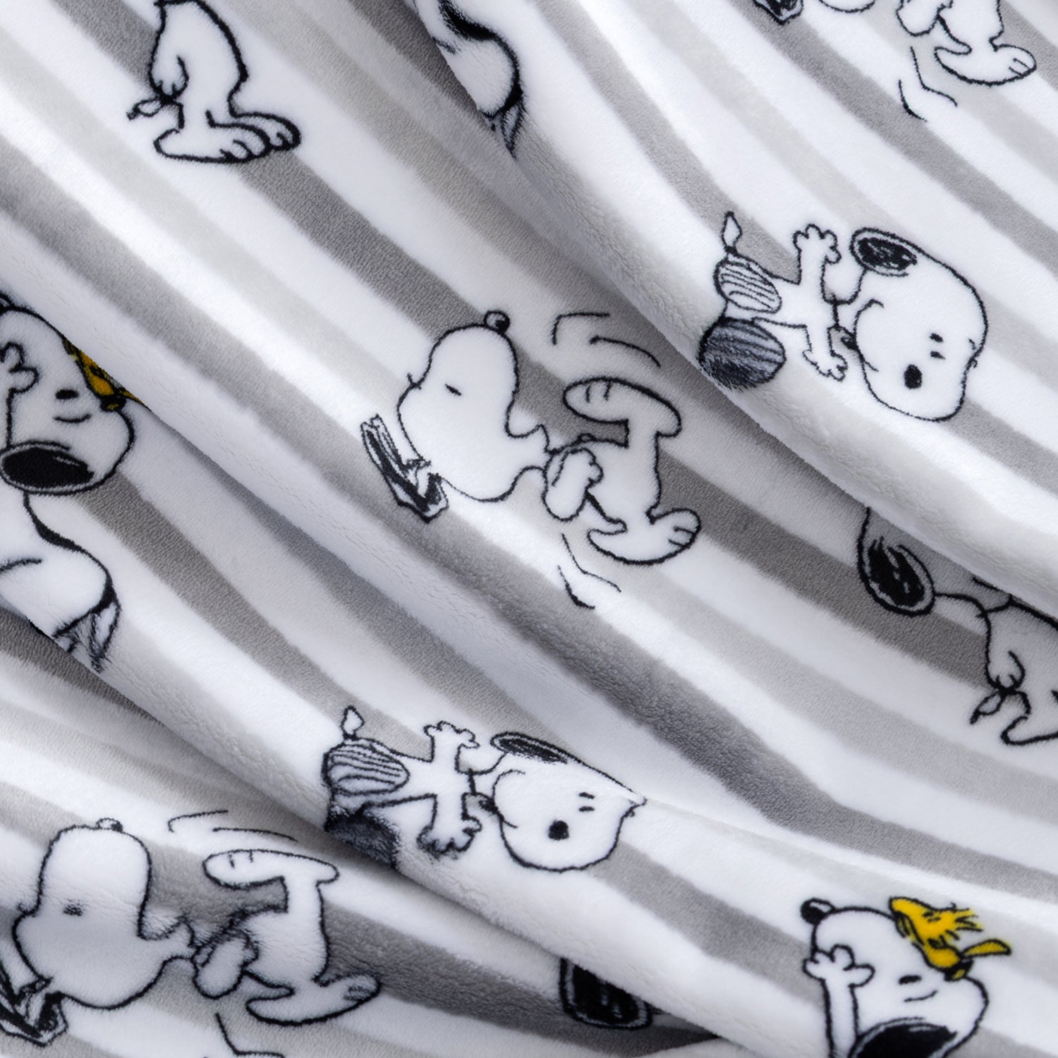 A grey striped peanuts throw blanket.