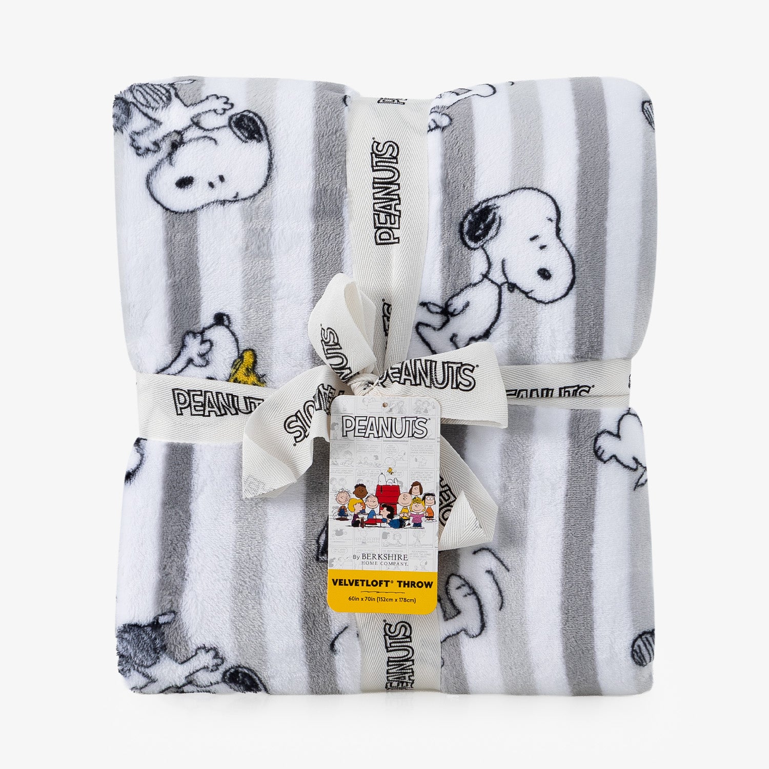 A folded Peanuts plush throw blanket with a white and gray striped pattern and cartoon character prints, tied with a white ribbon and tag.