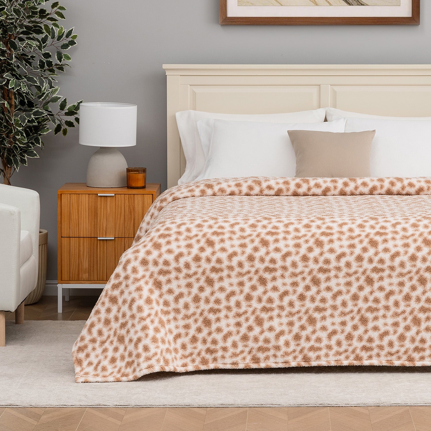 Bedroom with a bed featuring a leopard print blanket, nightstand, and lamp.