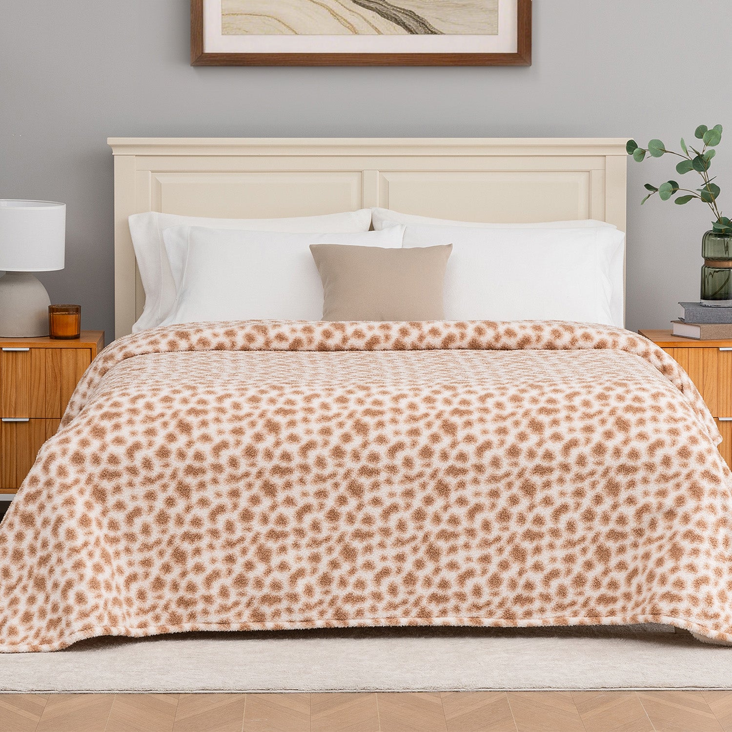 Bed with leopard print blanket in a bedroom setting