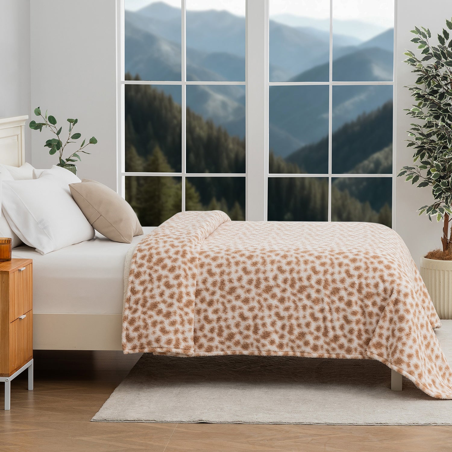 Bedroom with leopard print blanket, wooden nightstand, and mountain view.