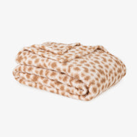 Folded blanket with brown and white pattern on a white background