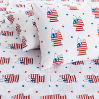 Peanuts-themed bedding set with Snoopy and Woodstock holding American flags on a white background.