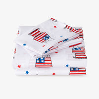 Folded bed sheet with American flag design on a white background