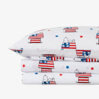 Pillowcases and bed sheets with dog and flag pattern on a white background