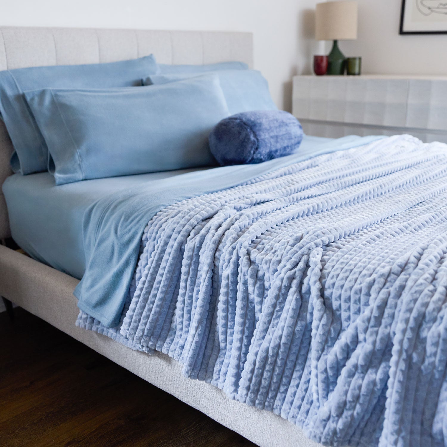 Blue bedding set on a bed in a bedroom