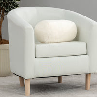 White armchair with a cushion on a gray background
