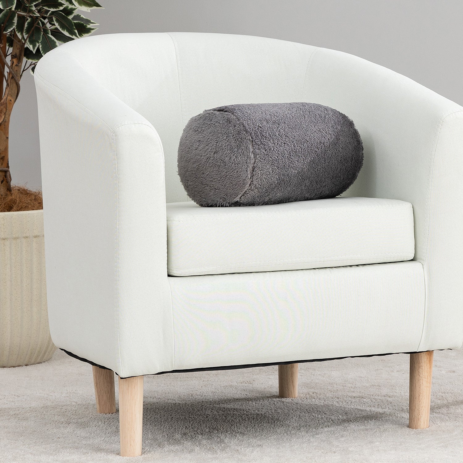 White armchair with a gray cushion on a neutral background
