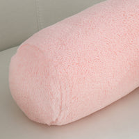 Pink cylindrical pillow on a light gray surface