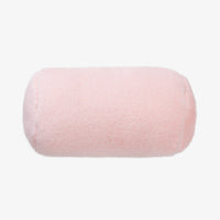 Pink cylindrical pillow on a white background