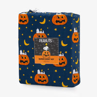 A packaged Peanuts-themed Queen Sheet Set by Bendislic, featuring a navy blue Halloween print with pumpkins, stars, and crescent moons, wrapped in a clear plastic bag with a front label.