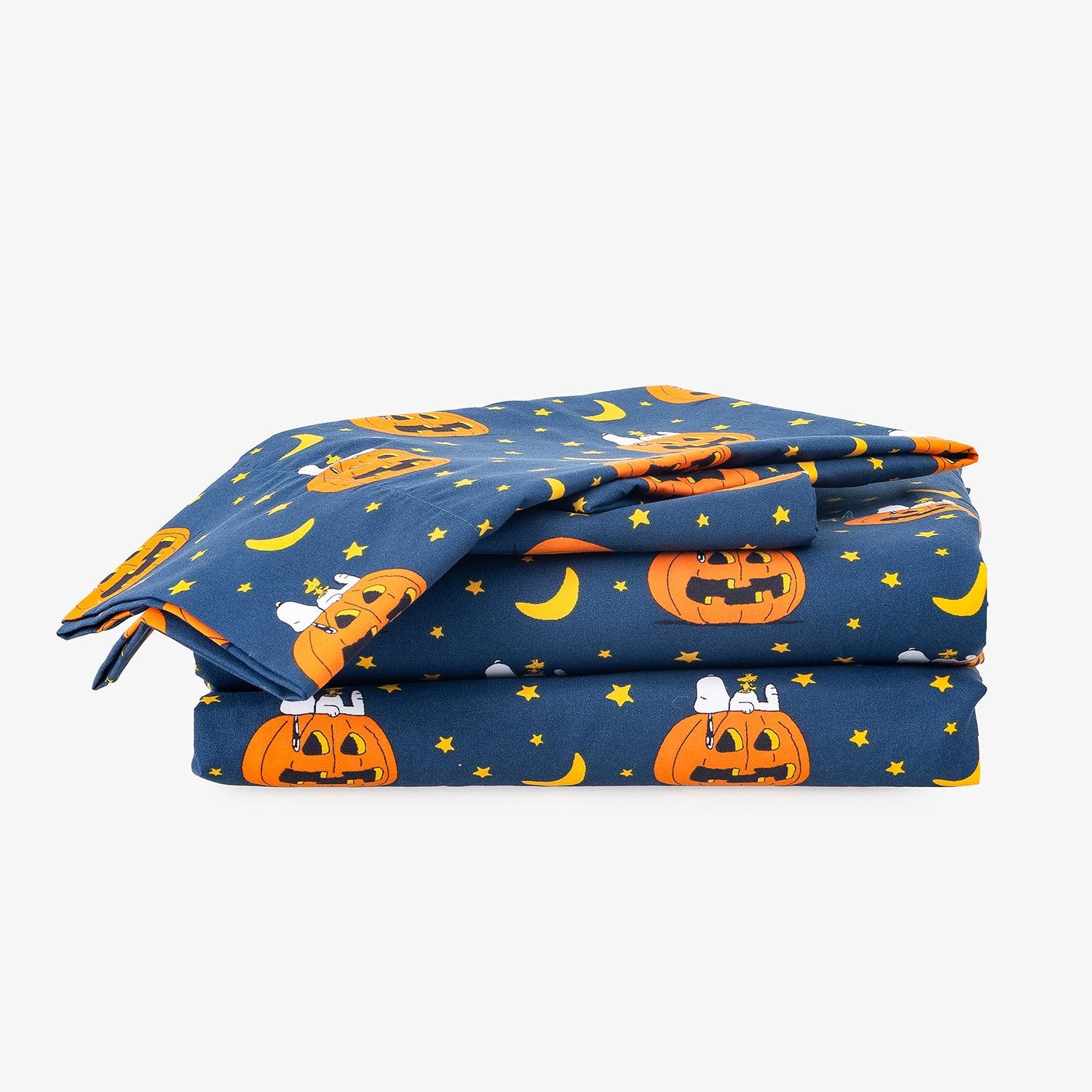 A folded navy blue fabric item, likely a blanket or comforter, featuring a Halloween print with orange jack-o'-lanterns, yellow crescent moons, and small white ghosts on a light gray background.