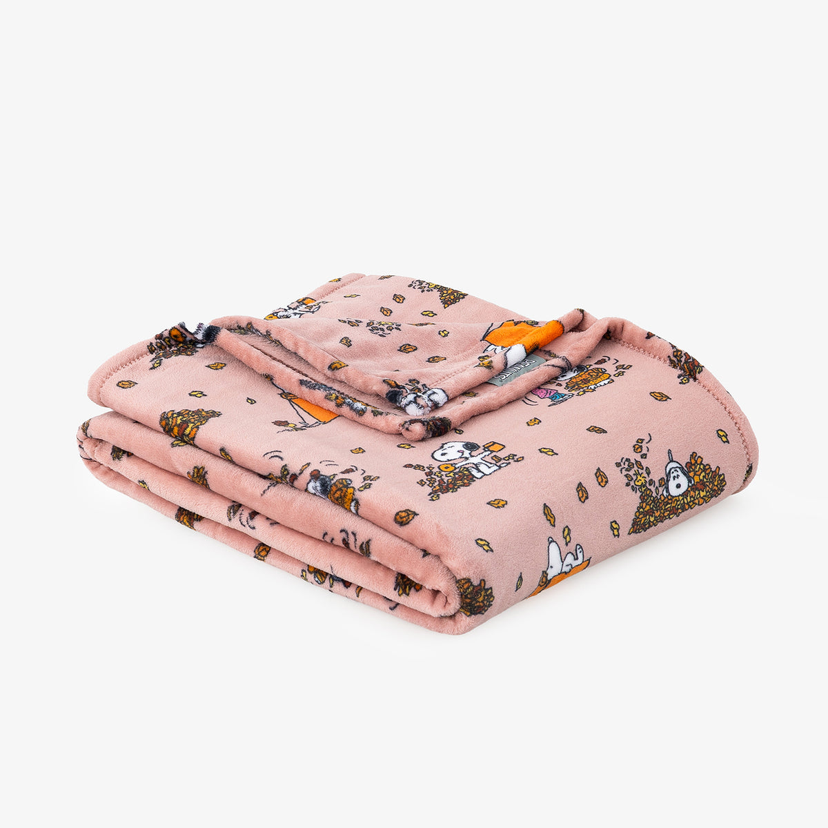 A folded pink blanket featuring a cartoon print of Snoopy and other characters, displayed on a clean white background.