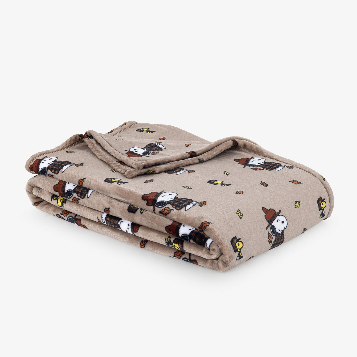 Printed VelvetLoft Throw featuring snoopy with leaves folded neatly on a white surface.