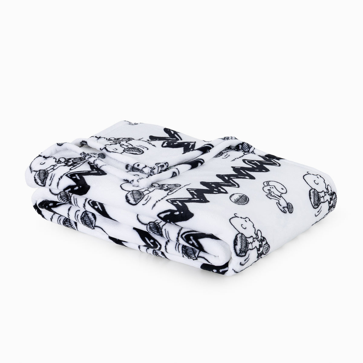 A folded white blanket featuring a black cartoon print of Snoopy and Woodstock, photographed on a clean white background.