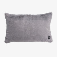 A rectangular gray faux fur pillow with a small black power button on the bottom right corner, shown against a plain white background.