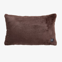 A brown heated lumbar pillow on a white surface.