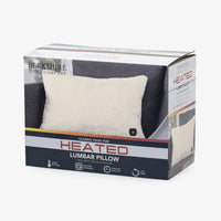 Berkshire Home Company Classic Faux Fur Heated Lumbar Pillow in its retail packaging, showing a cream-colored faux fur pillow on a dark gray sofa against a white background.