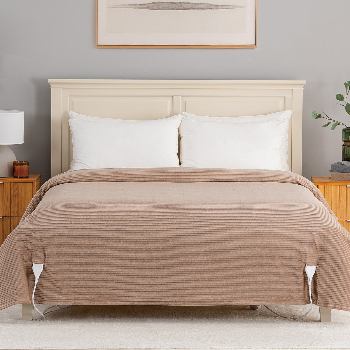 A bed dressed in a ribbed taupe-brown quilted coverlet with two white pillows, set against a light wood headboard in a styled bedroom scene.