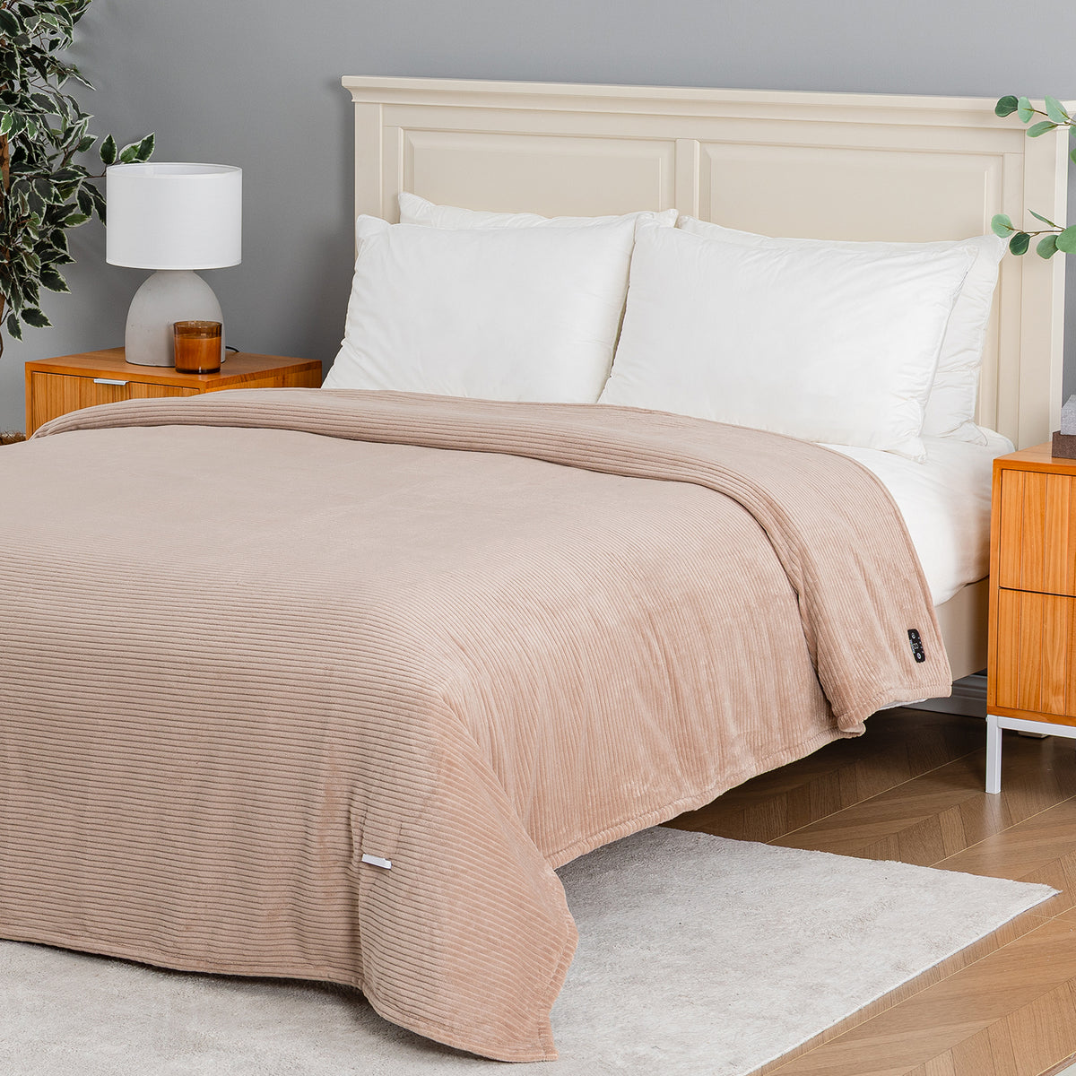 A beige corduroy comforter set on a bed with white pillows and sheets, styled in a modern bedroom with wooden nightstands, a lamp, and a gray wall.