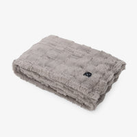 A folded gray plush electric blanket with a textured quilted pattern and a small black control button, shown on a clean white background.