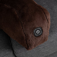 Close-up of a brown plush heated backrest pillow on a gray fabric surface, featuring a black power button with a white power symbol.