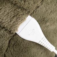 Close-up of a white electronic control module attached to a brown faux fur surface.