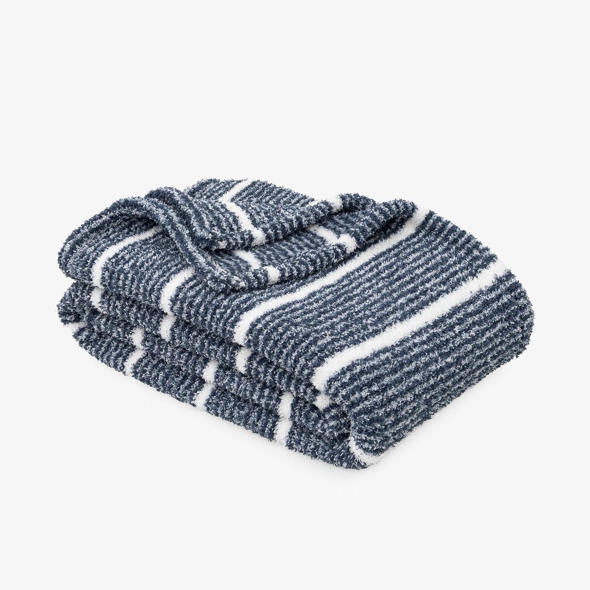 A folded striped knit blanket in navy blue and white, shown on a clean light gray background.