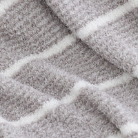 Close-up of a plush, textured fabric with a gray and white striped pattern.