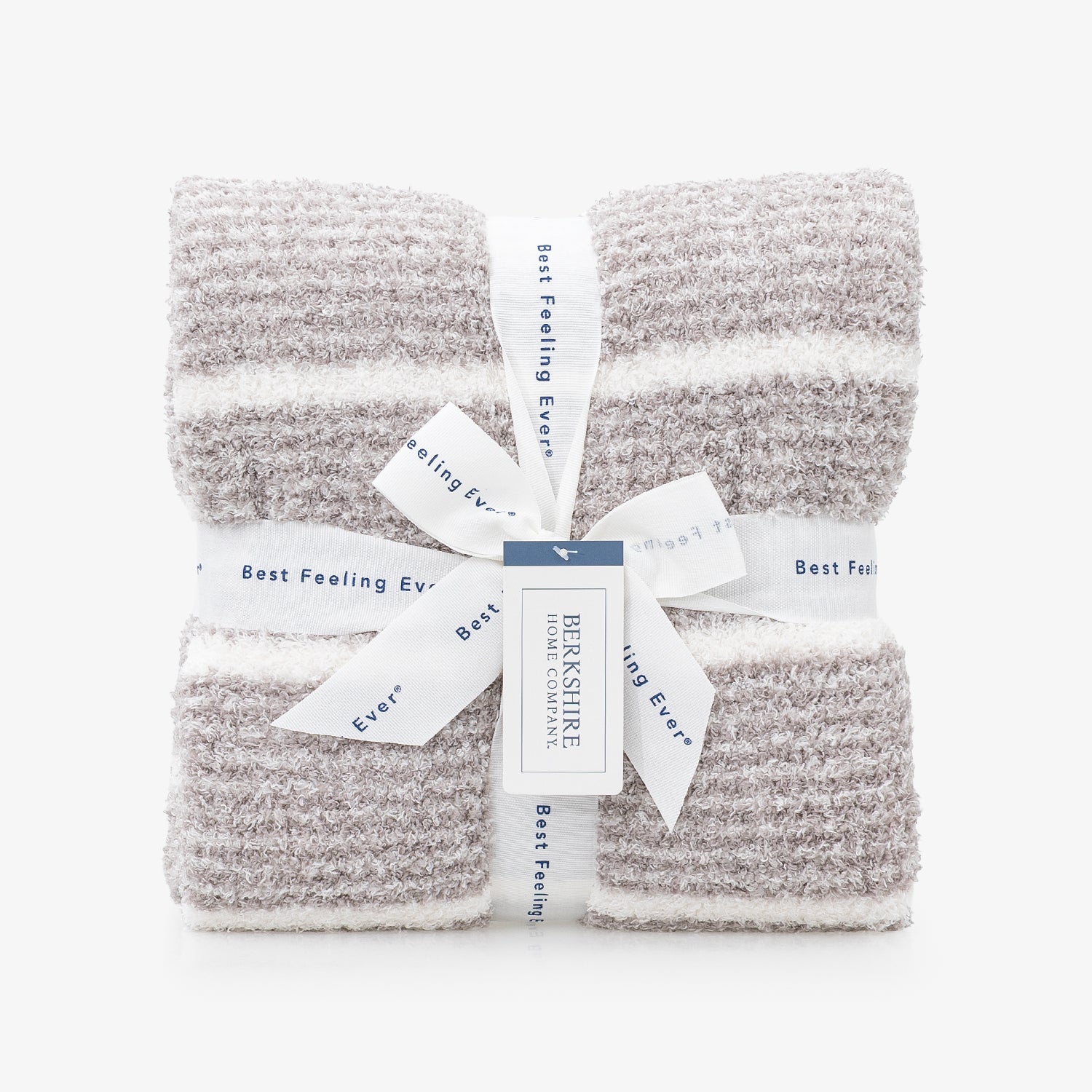 Two folded textured knit blankets in a heathered light gray and white stripe pattern, tied together with a white ribbon and paper tag from Bernsiere.