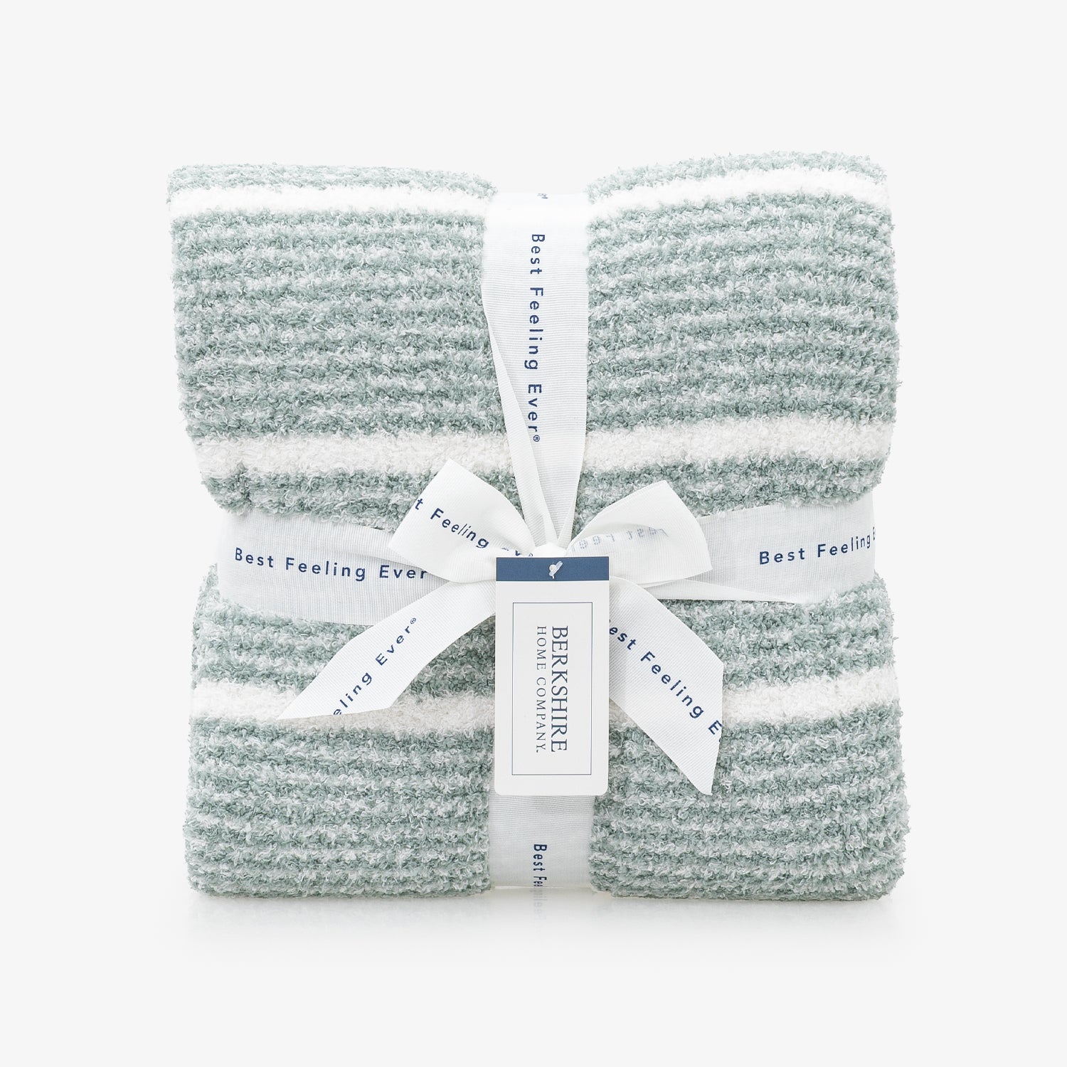 A folded knit blanket with horizontal sage green and white stripes, wrapped in a white ribbon with a central tag that reads 'BERRYSHIRE' and 'Best Feeling Ever'.