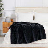 Premium VelvetLoft® Throw in Black, draped across the foot of a bed