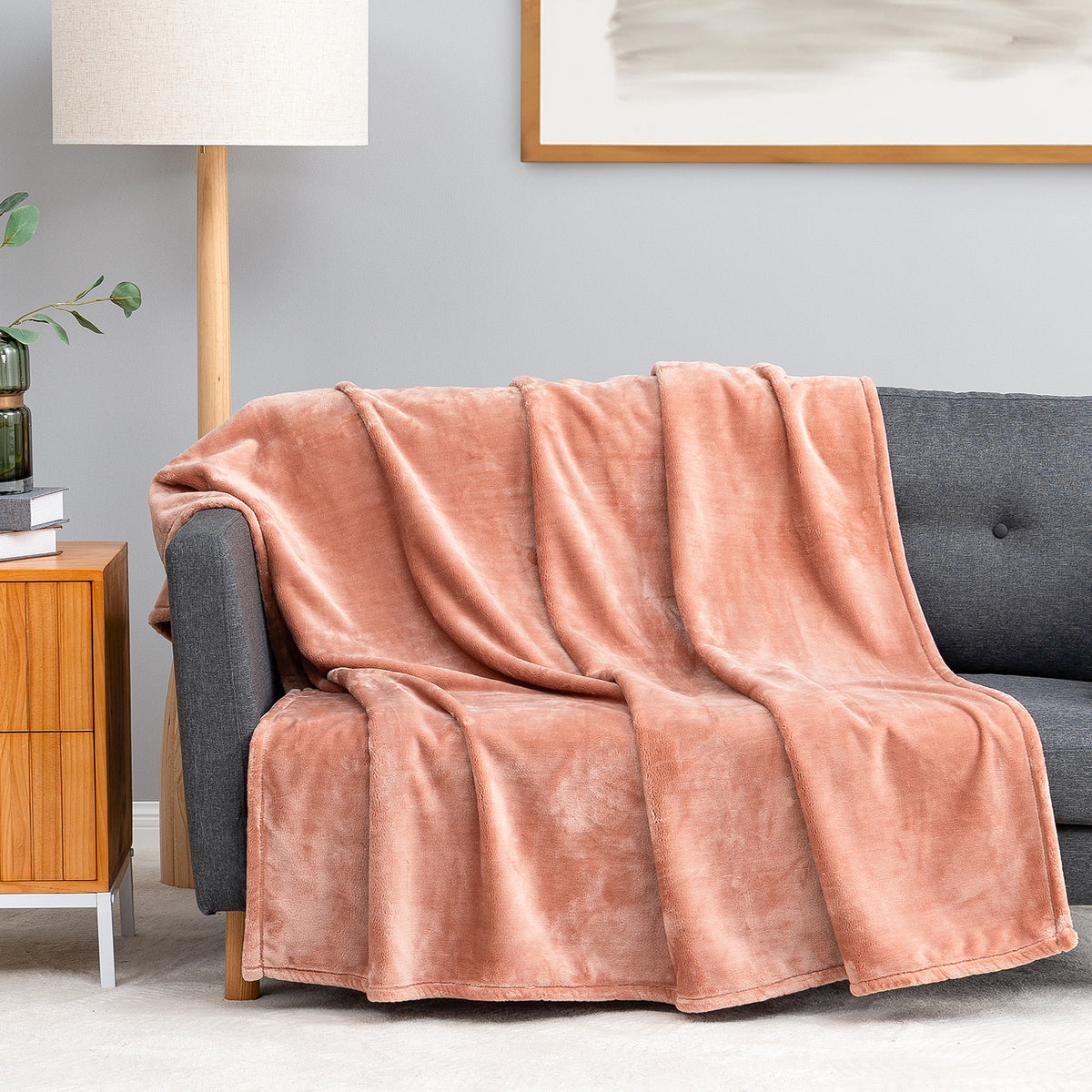 Premium VelvetLoft® Throw in Cafe Blush, draped over a gray sofa in a living room