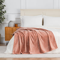 Premium VelvetLoft® Throw in Cafe Blush, draped across the foot of a bed