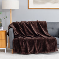 Premium VelvetLoft® Throw in Colt, draped over a gray sofa in a living room