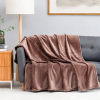 Premium VelvetLoft® Throw in Hazel, draped over a gray sofa in a living room