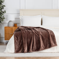 Premium VelvetLoft® Throw in Hazel, draped across the foot of a bed