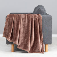 Premium VelvetLoft® Throw in Hazel, draped over the arm of a gray sofa, close view