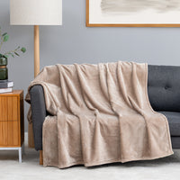 Premium VelvetLoft® Throw in Hummus, draped over a gray sofa in a living room