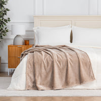 Premium VelvetLoft® Throw in Hummus, draped across the foot of a bed