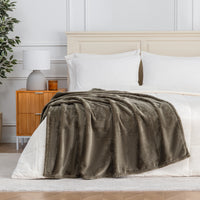 Premium VelvetLoft® Throw in Kalamata, draped across the foot of a bed