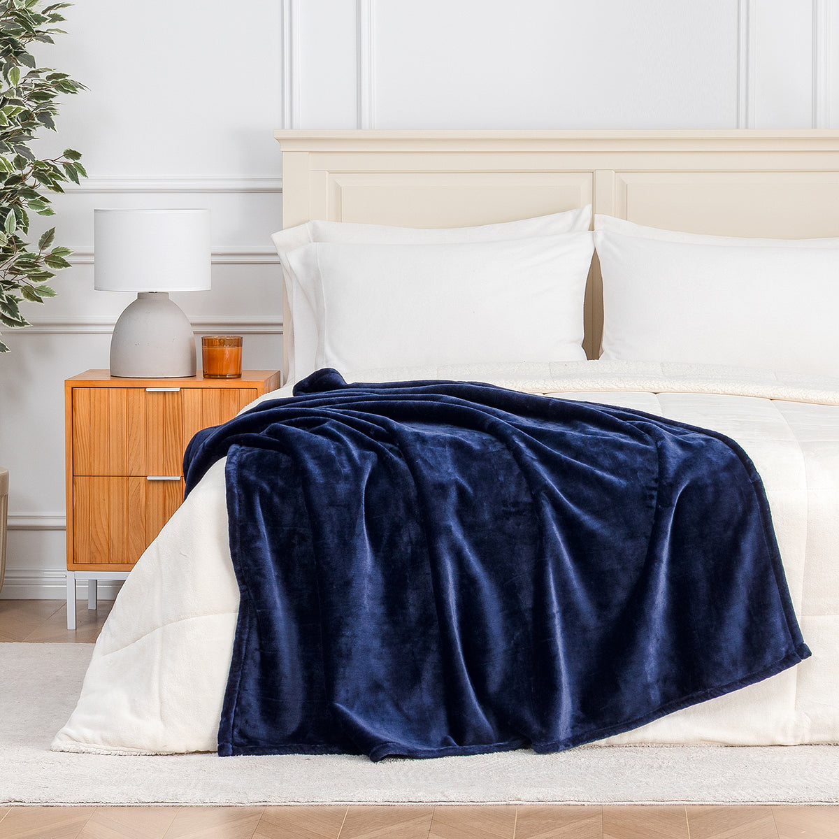 Premium VelvetLoft® Throw in Midnight Blue, draped across the foot of a bed