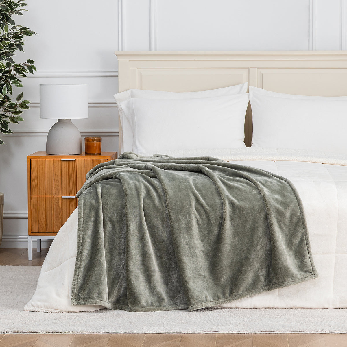 Premium VelvetLoft® Throw in Olive Shadow, draped across the foot of a bed