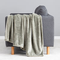 Premium VelvetLoft® Throw in Olive Shadow, draped over the arm of a gray sofa, close view