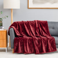 Premium VelvetLoft® Throw in Roanoke Red, draped over a gray sofa in a living room