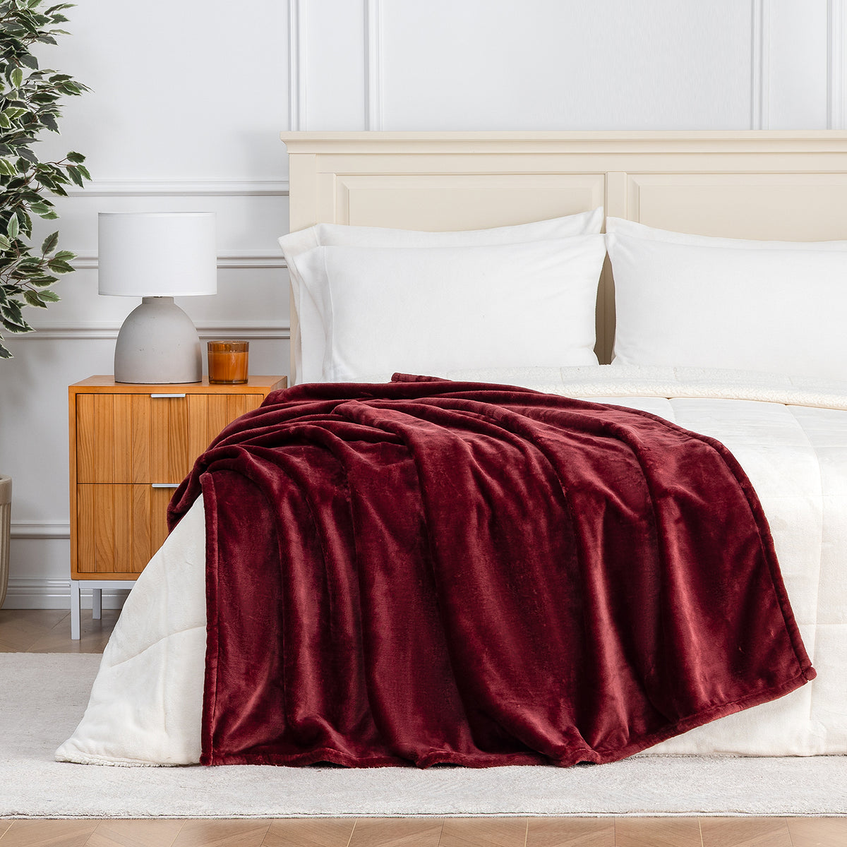Premium VelvetLoft® Throw in Roanoke Red, draped across the foot of a bed