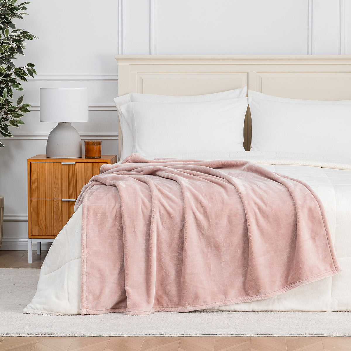 Premium VelvetLoft® Throw in Rose Smoke, draped across the foot of a bed